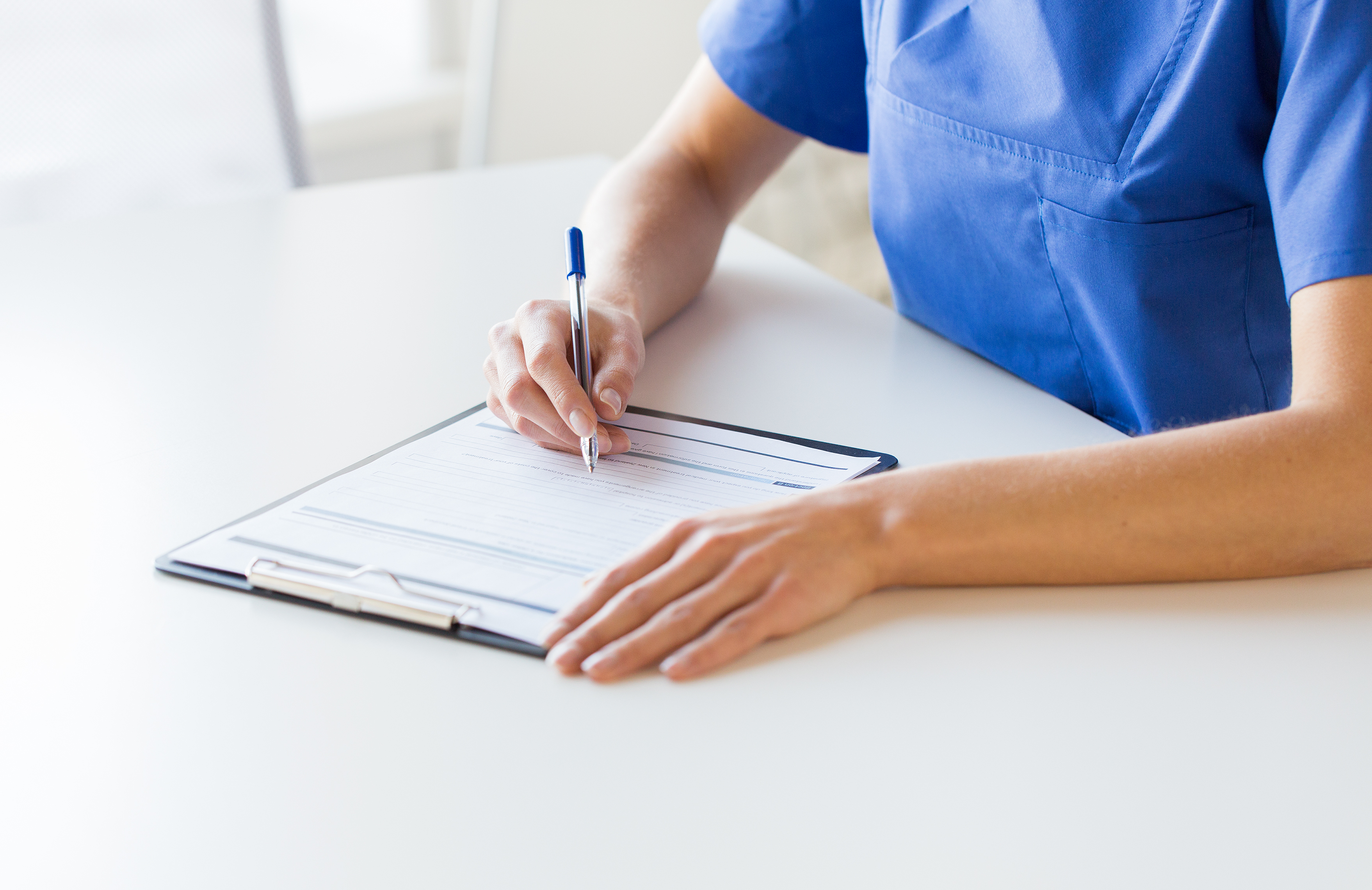 Photo representing a nurse reviewing information about infection prevention