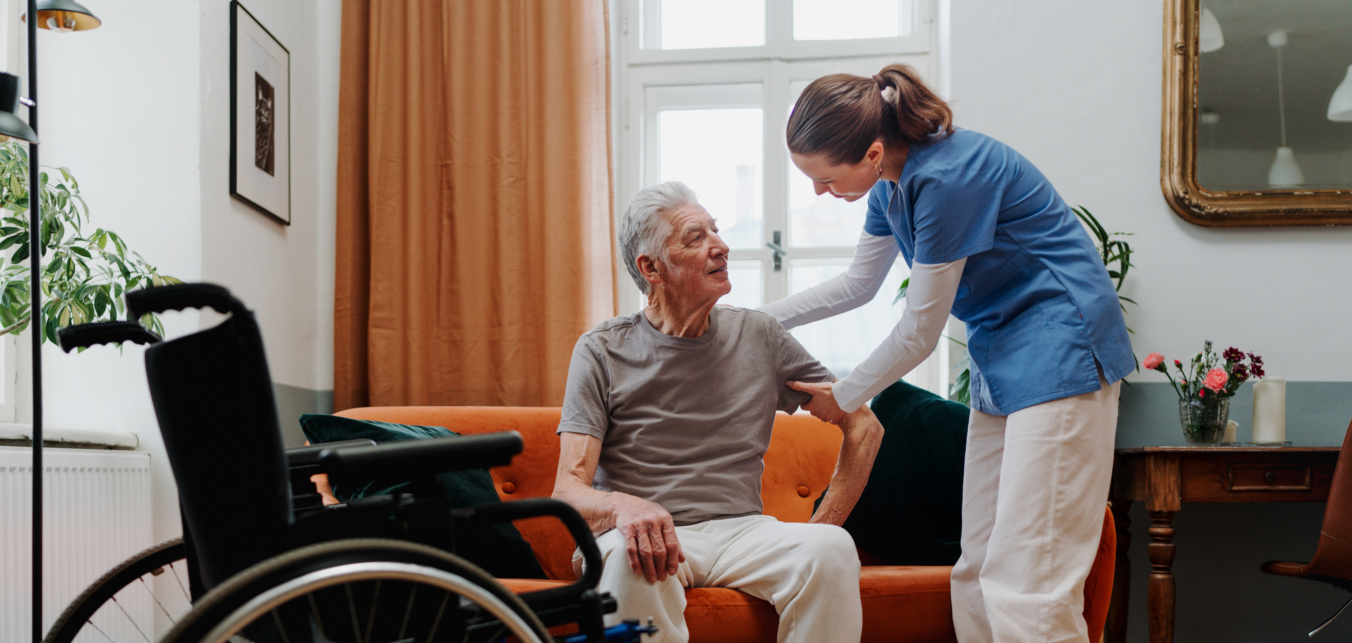 Photo representing a nurse using proper body mechanics while assisting a client